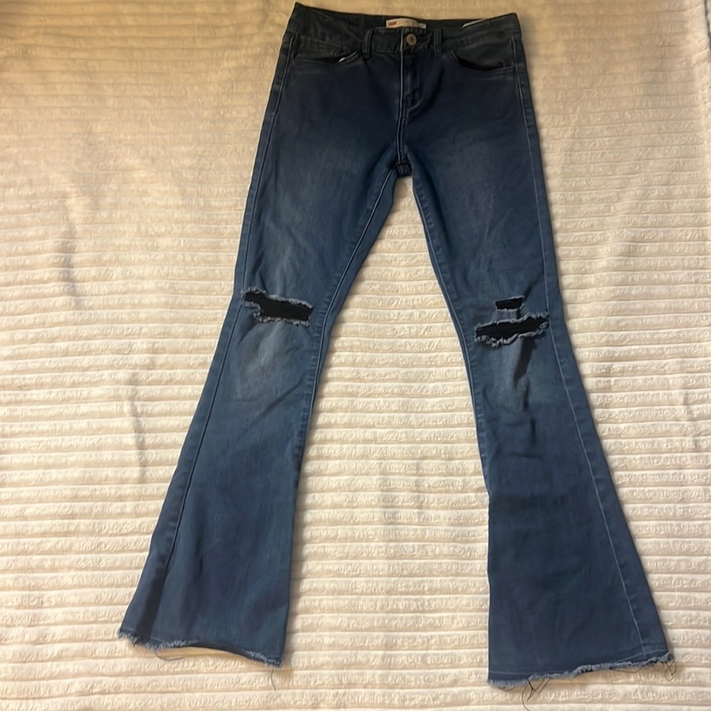 Levi dark blue flared ripped jeans.